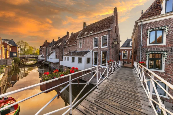 Famous medieval \'hanging kitchens\' over the Damsterdiep in the historic town of Appingedam under spectacular sky, Groningen, Holland.