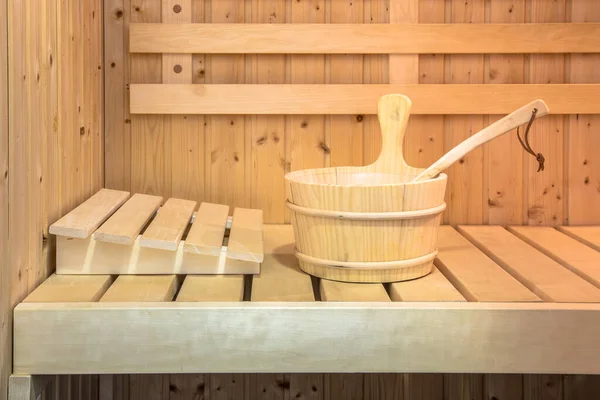 Wooden bucket on seat in Interior of Finnish sauna