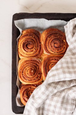 Yeni pişirilmiş ev yapımı tarçınlı rulo ya da tarçınlı kek. Geleneksel tarçınlı tatlı çörekleri kıvrıldı. Üst görünüm.