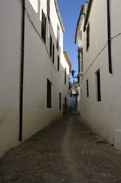 White street in Ronda, a city of the province of Malaga, Andalusia, Spain. Ronda is situated in a very mountainous area about 750 m above mean sea level.