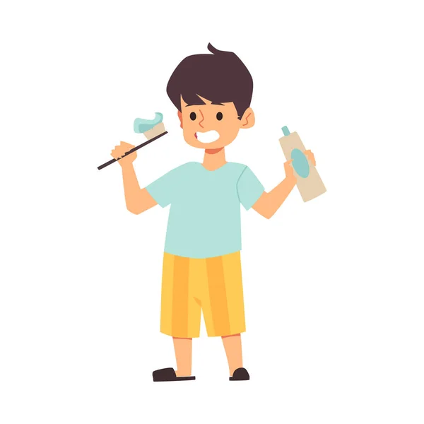 Bonito desenho animado menino segurando pasta de dentes em suas mãos, escova de dentes —  Vetores de Stock