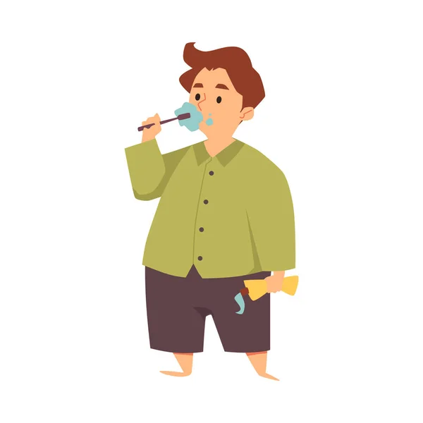 Мальчик в пижаме чистит зубы зубной щеткой, держа зубную пасту в плоской — стоковый вектор