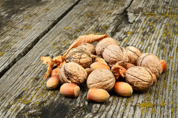 Nueces y avellanas sobre fondo de madera — Foto de Stock