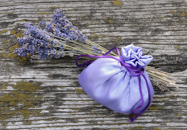 Λεβάντα τσάντα και λουλούδι σε έναν ξύλινο πίνακα — Φωτογραφία Αρχείου