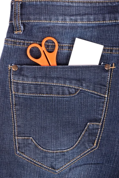 Scissors and sticker in the blue jeans pocket — Stock Photo, Image