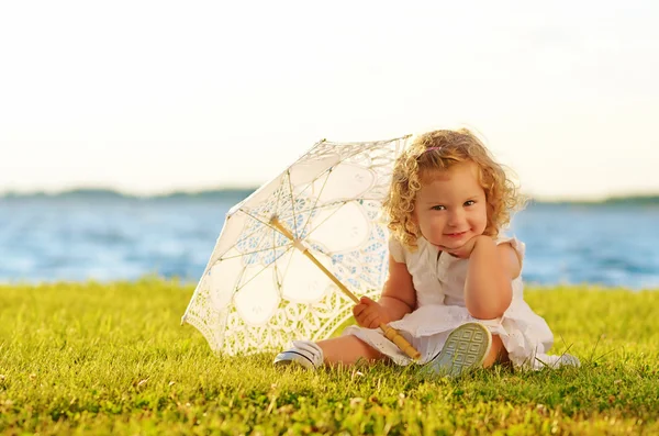 Young beautiful girl posing for the camera in white dress — Stock Photo, Image