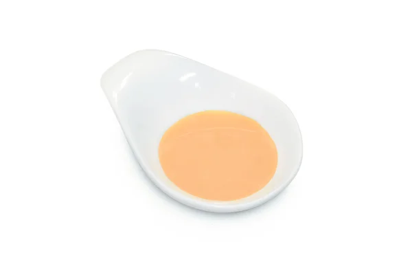 Білий шоколадний соус у білій мисці — стокове фото