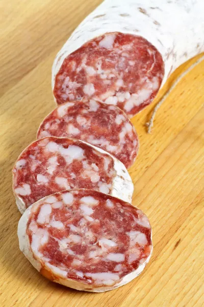 Salami in slices on cutting board — Stock Photo, Image