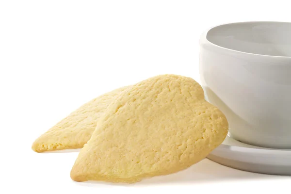 Hartvormige koekjes naast een koffiekopje — Stockfoto