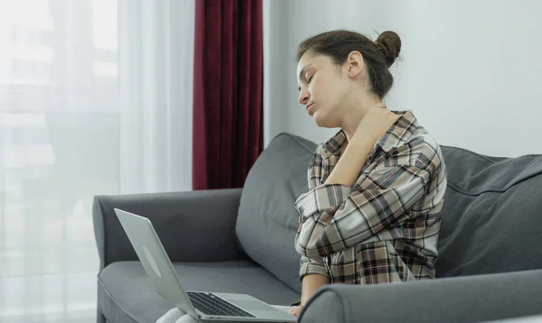 Working girl at the computer, Problems with the spine and neck and back. Consequences of a sedentary lifestyle.