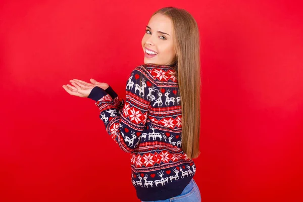 Young Caucasian Girl Wearing Christmas Sweater Pointing Aside Hands Open — Stock Photo, Image