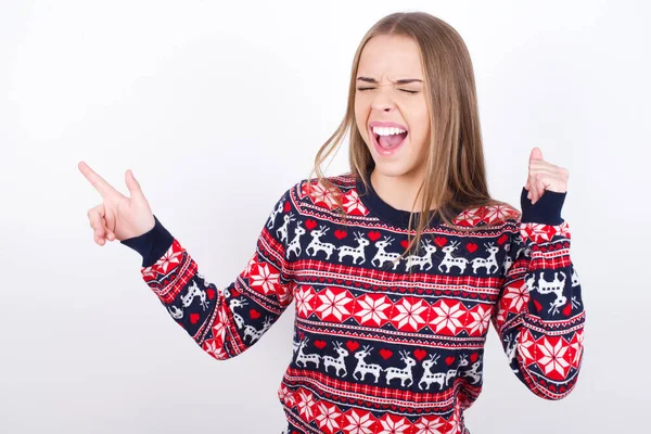Cheerful Young Caucasian Girl Wearing Christmas Sweaters White Background Showing — Stock Photo, Image