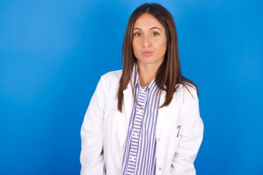 Hoş görünümlü güzel Latin bir kadın, dudaklarını büzüyor, kameraya bakıyor, insan yüz ifadeleri...