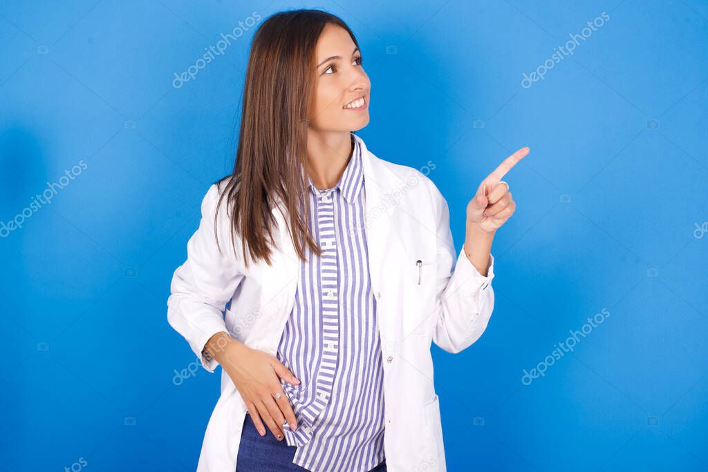 Smiling beautiful young woman indicating finger empty space showing best low prices