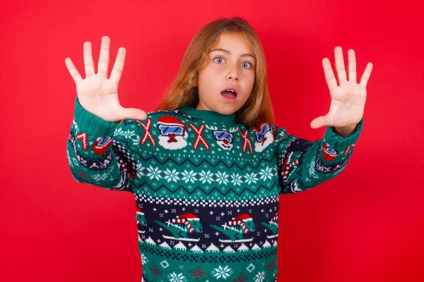 Dissatisfied Funny Brunette Kid Girl Knitted Sweater Christmas Red Background — Stock Photo, Image
