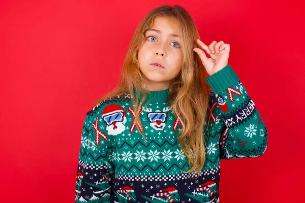 Шокована Дівчинка Брюнетка Язаному Светрі Різдво Червоному Тлі Показує Щось — стокове фото