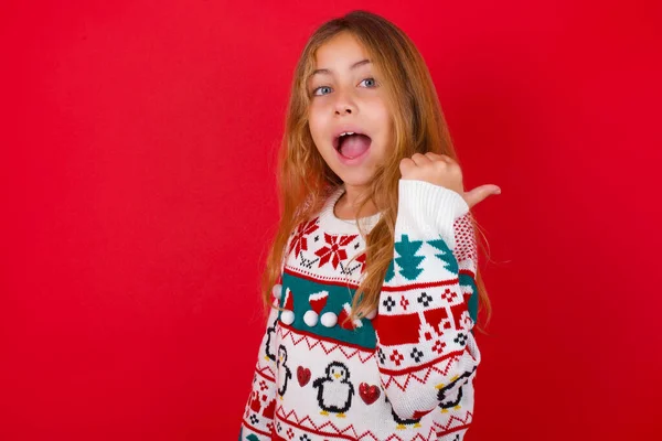 Impressed Brunette Kid Girl Knitted Sweater Christmas Red Background Point — Stock Photo, Image