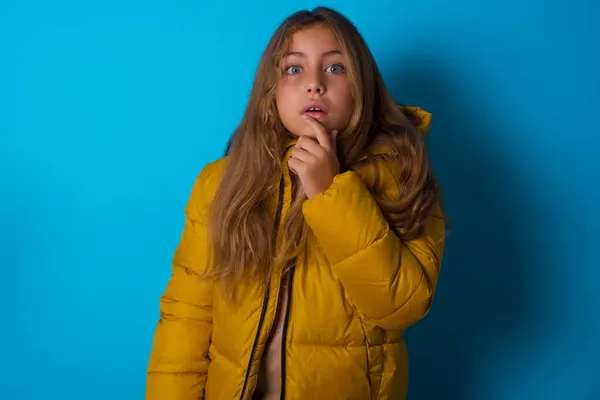 Nervous Puzzled Brunette Kid Girl Wearing Yellow Jacket Blue Background — Stock Photo, Image