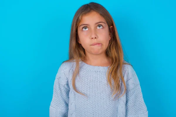 Brunette Kid Girl Wearing Blue Knitted Sweater Blue Background Making — Stock Photo, Image