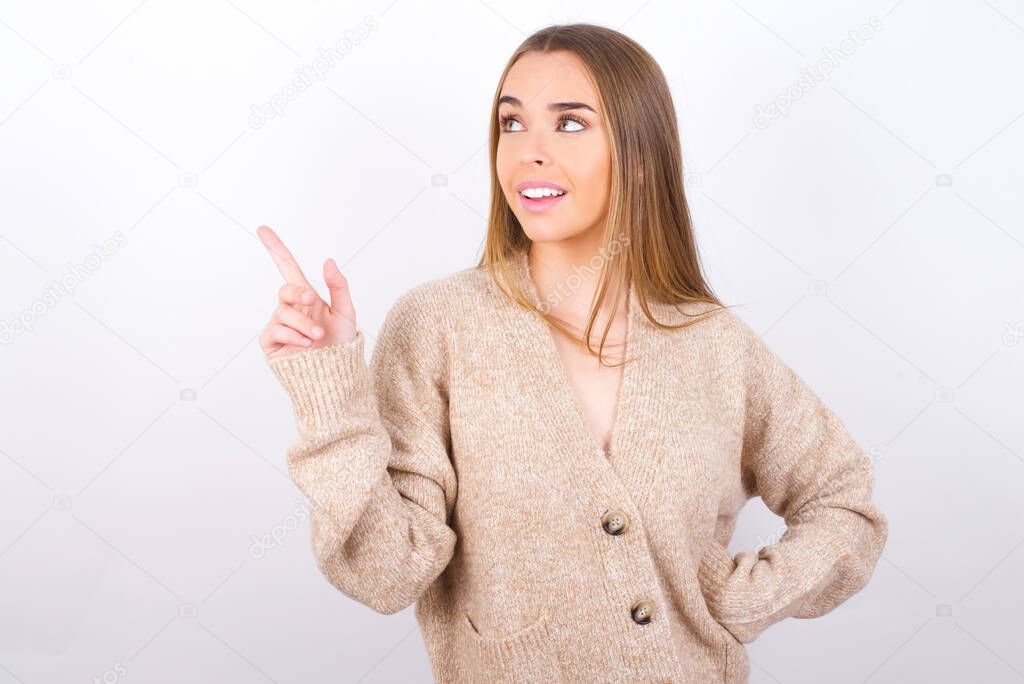 young woman pointing with finger on empty space