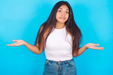 Kafası karışmış, beyaz kolları açık, omuzlarını silkeleyip 