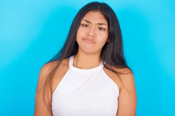 Young Hispanic Girl Wearing White Tank Top Blue Background Crosses — Stockfoto