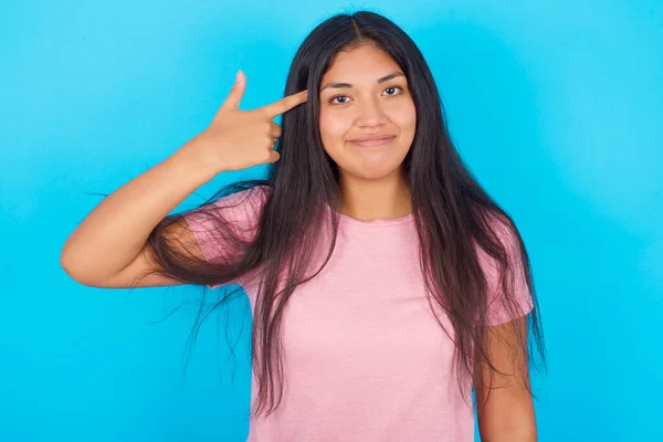 Unhappy Young Hispanic Girl Wearing Pink Shirt Blue Background Curves — Fotografia de Stock