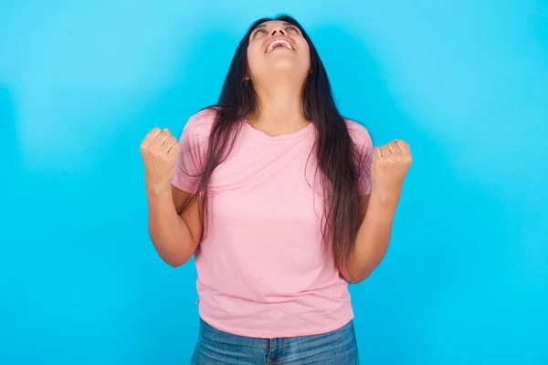 Young Hispanic Girl Wearing Pink Shirt Blue Background Looks Excitement — 图库照片