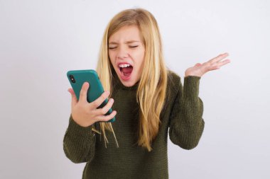 Beyaz arka planda yeşil örülü süveter giyen kızgın beyaz kız telefonda bağırıyor, bir çalışanla tartışıyor. İşte sorunlar var..