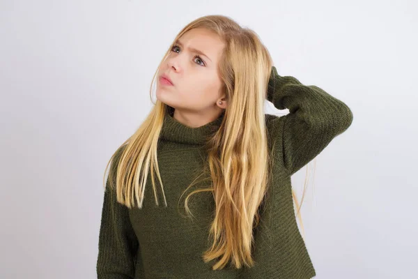 Caucasian Kid Girl Wearing Green Knitted Sweater White Background Confuse — Stock Photo, Image