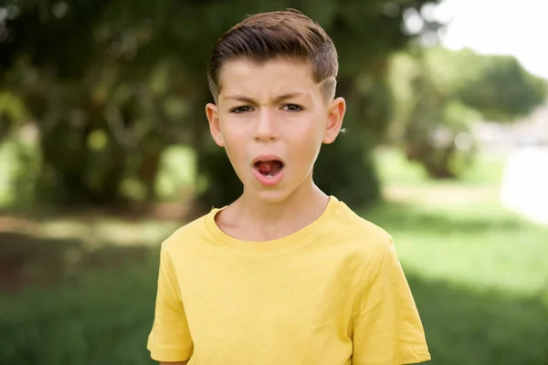 Beautiful Caucasian Little Kid Boy Wearing Yellow Shirt Standing Outdoors — Stock Photo, Image
