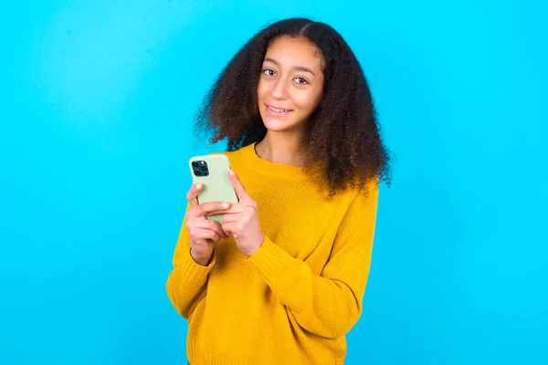 Piękna Nastolatka Dziewczyna Żółtym Swetrze Stojącym Niebieskim Tle Mock Przestrzeń — Zdjęcie stockowe