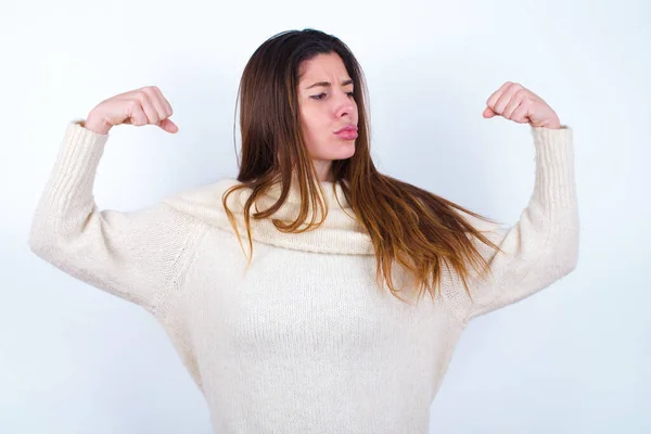 Young Woman Wearing White Sweater White Background Showing Arms Muscles — Stock Photo, Image