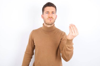 young caucasian man wearing turtleneck over white background angry gesturing typical italian gesture with hand, looking to camera