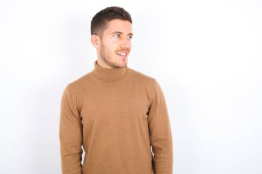 young caucasian man wearing turtleneck over white background very happy and excited about new plans.