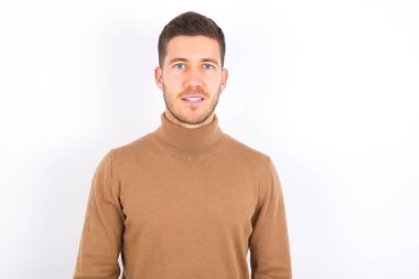 young caucasian man wearing turtleneck over white background with a happy and cool smile on face. Lucky person.