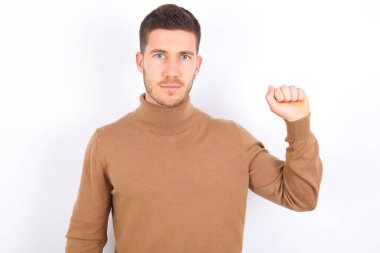 young caucasian man wearing turtleneck over white background pointing up with fingers number ten in Chinese sign language Shi
