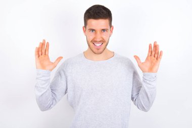Crazy outraged young caucasian man wearing casual clothes over white background screams loudly and gestures angrily yells furiously. Negative human emotions feelings concept