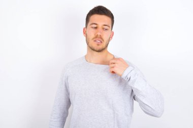 young caucasian man wearing casual clothes over white background stressed, anxious, tired and frustrated, pulling shirt neck, looking frustrated with problem