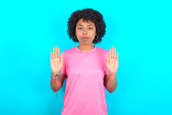 Serious Young African American Woman Wearing Pink Shirt Blue Background — Stockfoto