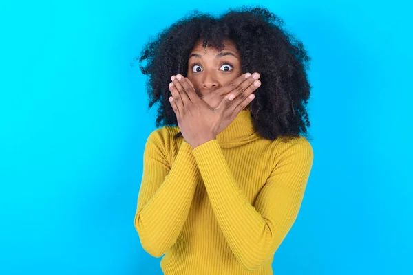Afro Amerikaanse Vrouw Draagt Gele Coltrui Blauwe Achtergrond Geschokt Bedekken — Stockfoto