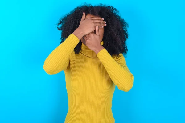 Mujer Afroamericana Con Cuello Alto Amarillo Sobre Fondo Azul Cubriendo —  Fotos de Stock