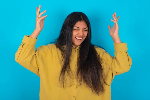 Young Latin Woman Wearing Yellow Shirt Blue Background Goes Crazy — Photo