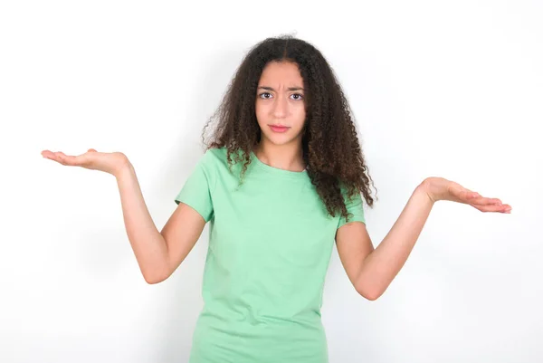 Indignant Teenager Girl Afro Hairstyle Wearing White Shirt Green Background — 스톡 사진