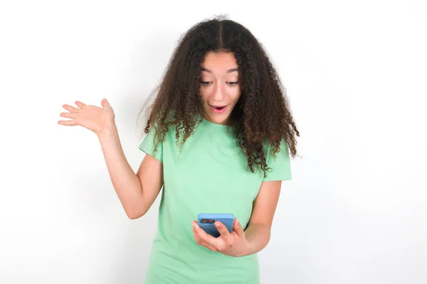 Teenager Girl Afro Hairstyle Wearing White Shirt Green Background Holding — Foto de Stock