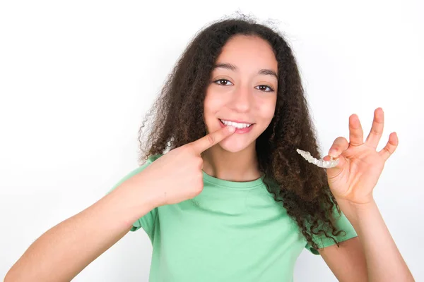 Teenager Girl Afro Hairstyle Wearing White Shirt Green Background Holding — Fotografia de Stock