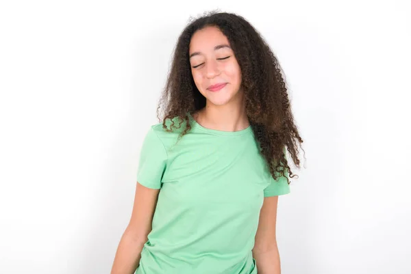 Positive Teenager Girl Afro Hairstyle Wearing White Shirt Green Background — стоковое фото