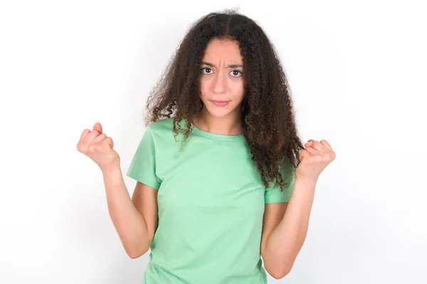 Irritated Teenager Girl Afro Hairstyle Wearing White Shirt Green Background — Stockfoto