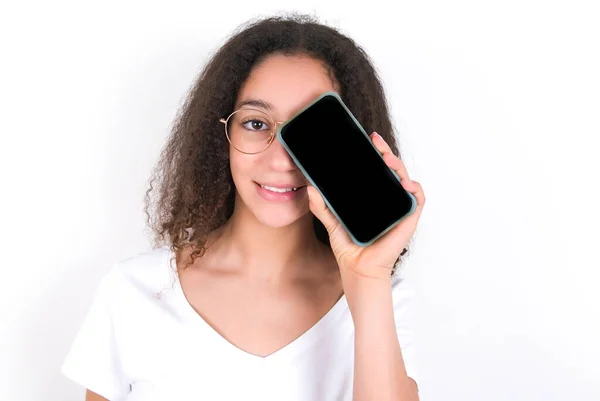 Teenager Girl Afro Hairstyle Wearing White Shirt White Background Holding — стоковое фото