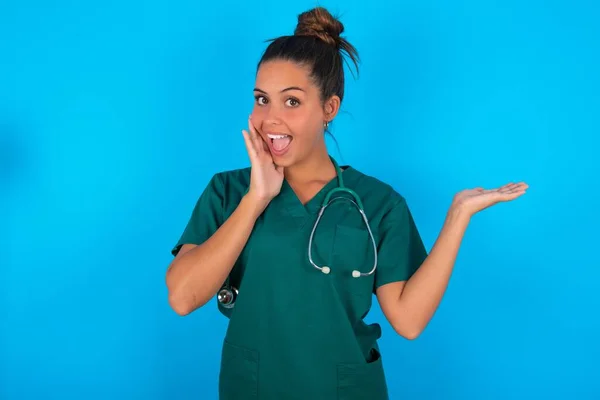 Louco Bela Mulher Médica Hispânica Vestindo Uniforme Médico Verde Sobre — Fotografia de Stock